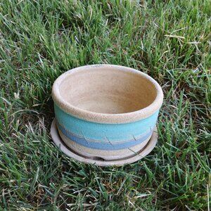 Stoneware pottery planter with an attached saucer